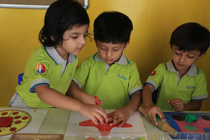 Nursery children making art with paper shapes at Edistää Preschool, Wadala West, Mumbai