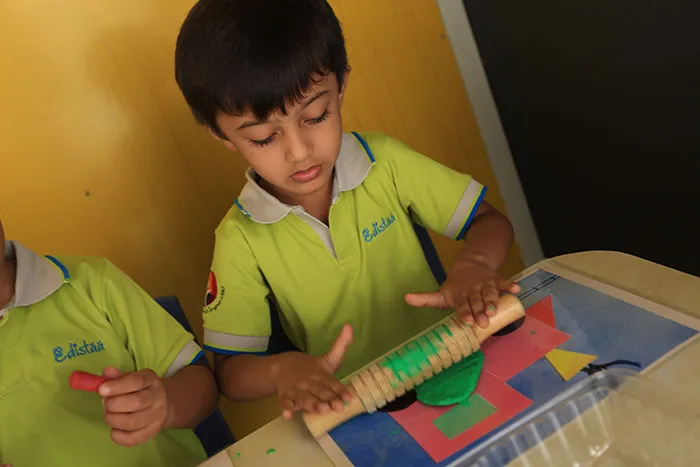 Nursery child working on a shape puzzle at Edistää Preschool, Wadala West, Mumbai