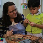 Nursery child weaving with his teacher at Edistää Preschool, Wadala West, Mumbai