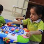 Toddler exploring an activity table at Edistää Preschool, Wadala West, Mumbai
