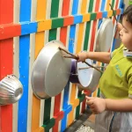 Toddler enjoying water play outdoors at Edistää Preschool, Wadala West, Mumbai